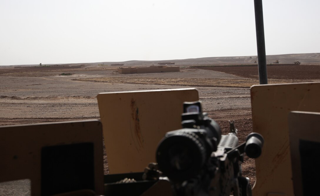 A turret gunner’s view enables them to see far and wide, watching for suspicious activity and observing life as it happens around them during a combat logistics patrol in Helmand province, Afghanistan, July 14, 2014. The turret gunners with CLB-7 act as the eyes and ears while being the guardian angels of each combat logistics patrol conducted during their deployment. (Photo Courtesy of Cpl. Alex Roberts, CLB-7)