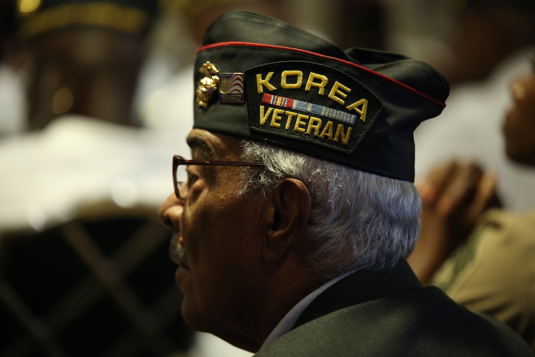 Thomas Cork, an original Montford Point Marine and survivor of the tattle of the Chosin Reservoir, listens to a current operations brief at the 49th Annual Montford Point Marine Association Convention here, July 18, 2014. Lt. Gen. Ronald L. Bailey, deputy commandant of Plans, Policies and Operations, addressed chapter leaders, members and original Montford Point Marines on current operations, informing the audience of ongoing global Marine Corps missions. (U.S. Marine Corps photo by Cpl. Tiffany Edwards)