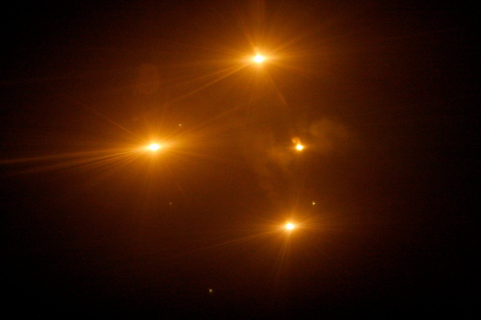 Flares dropped out of a KC-130J by Marines with Marine Aerial Refueling Transportation Squadron 352 burn bright in the night sky above Helmand province, Afghanistan, during a battlefield illumination mission July 18, 2014. Battlefield illumination missions are implemented to light up areas in support of nighttime coalition operations within Regional Command (Southwest). (U.S. Marine Corps Photo by: Sgt. Frances Johnson/Released)