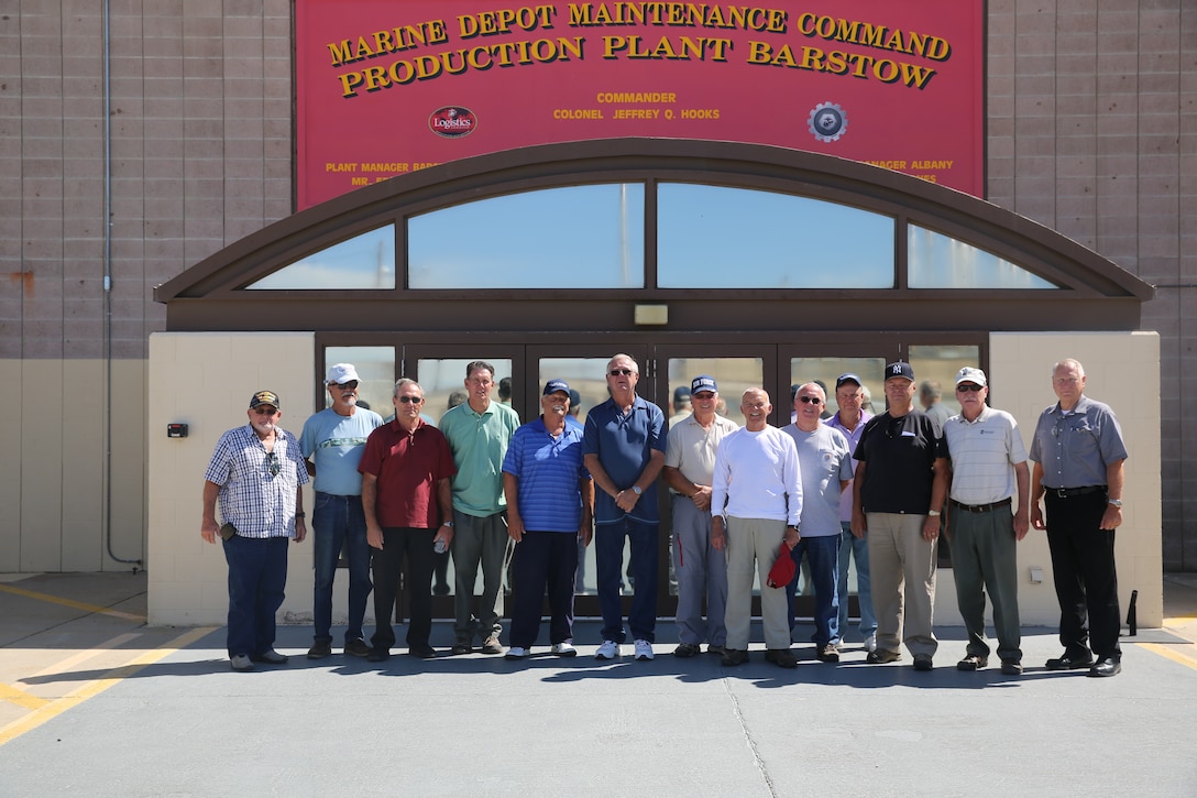 The ROMEOS, Retired Old Men Eating Out, from the Sun City retirement community in Apple Valley, Calif., pose for a group picture in front of Production Plant Barstow, Marine Depot Maintenance Command, July 21. The ROMEOS stay active and social during retirement by going out to eat each month and doing a different activity together.