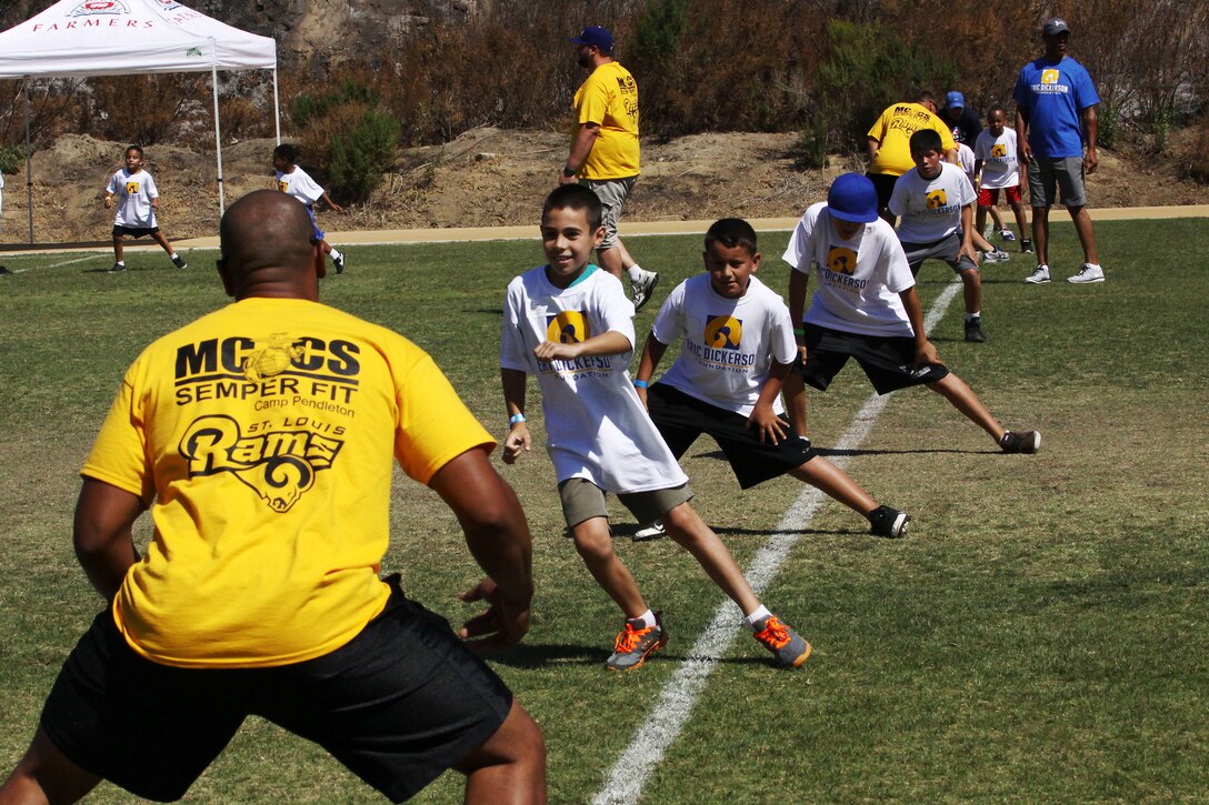 Young aspiring athletes, ages 6-17, run various conditioning and training courses while being coached by former professional football players during the 4th Annual Eric Dickerson Foundation Youth Football and Cheer Camp, here, July 10 and 11.