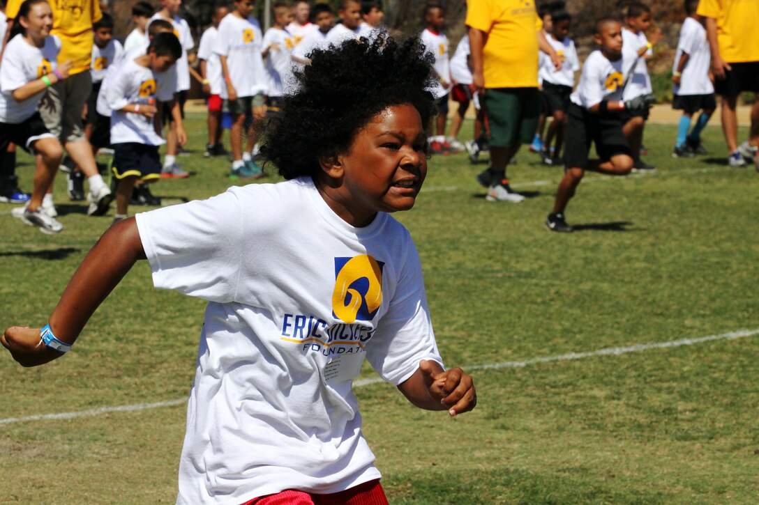 Young aspiring athletes, ages 6-17, run various conditioning and training courses while being coached by former professional football players during the 4th Annual Eric Dickerson Foundation Youth Football and Cheer Camp, here, July 10 and 11.