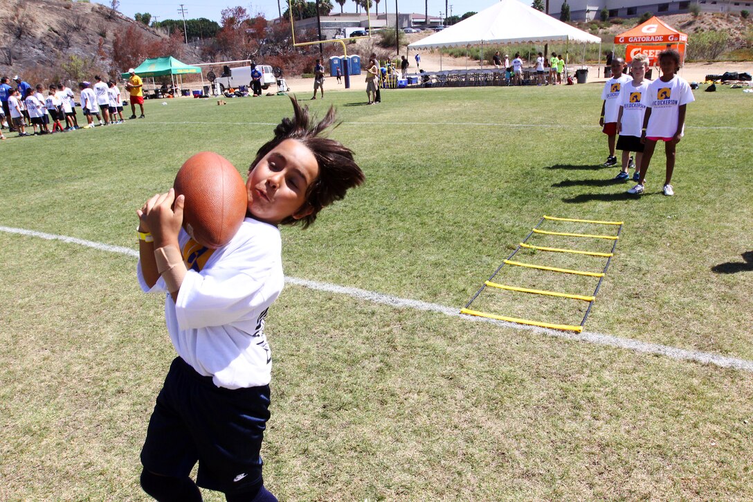 Young aspiring athletes, ages 6-17, run various conditioning and training courses while being coached by former professional football players during the 4th Annual Eric Dickerson Foundation Youth Football and Cheer Camp, here, July 10 and 11.