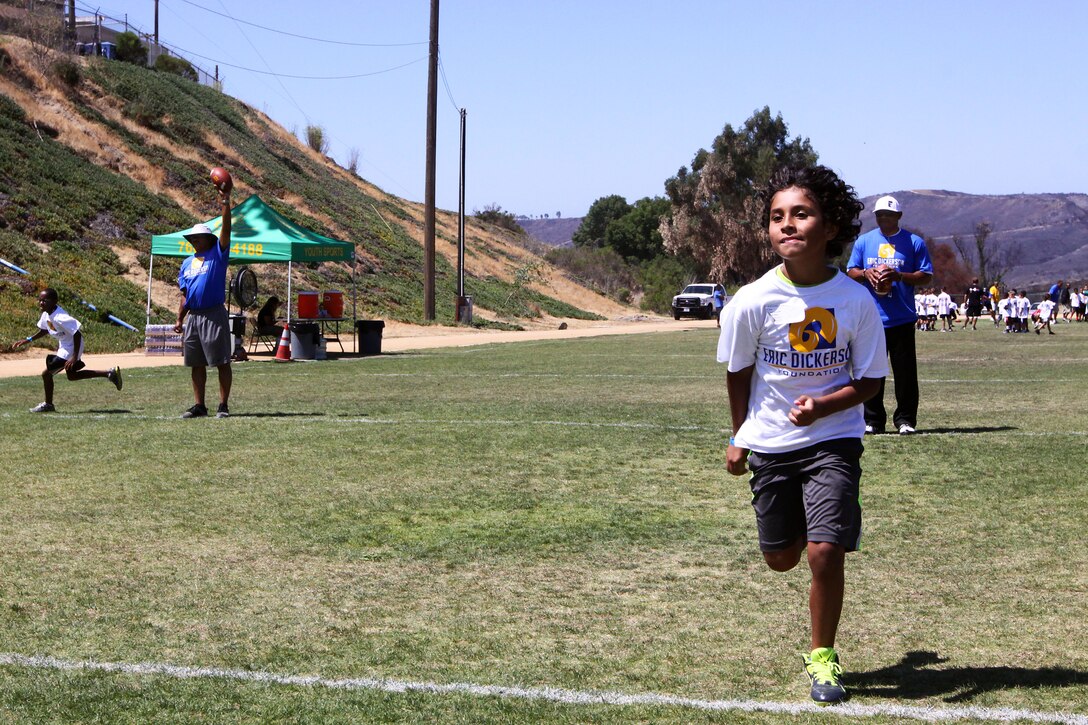 Young aspiring athletes, ages 6-17, run various conditioning and training courses while being coached by former professional football players during the 4th Annual Eric Dickerson Foundation Youth Football and Cheer Camp, here, July 10 and 11.
