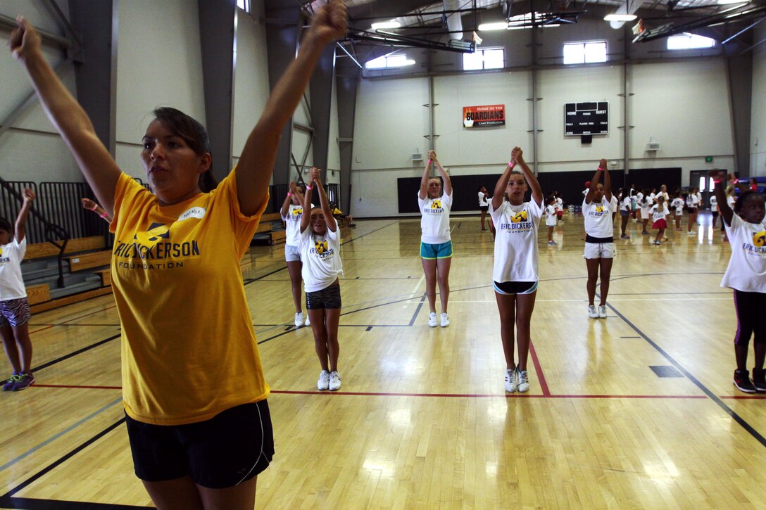 Young aspiring athletes, ages 6-17, run various conditioning and training courses while being coached by former professional football players during the 4th Annual Eric Dickerson Foundation Youth Football and Cheer Camp, here, July 10 and 11.