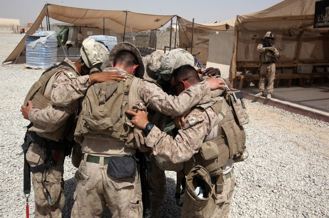 Turret gunners with Combat Logistics Battalion 7 pray over each other before a combat logistics patrol aboard Camp Leatherneck, Afghanistan, July 14, 2014. The turret gunners with CLB-7 act as the eyes and ears while being the guardian angels of each combat logistics patrol conducted during their deployment. (U.S. Marine Corps Photo by Sgt. Frances Johnson/Released)