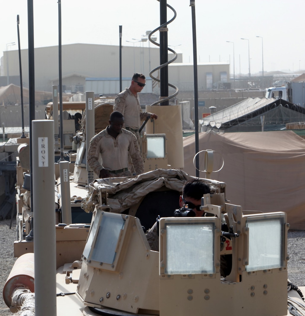 Turret gunners with Combat Logistics Battalion 7 prepare their vehicles before a combat logistics patrol aboard Camp Leatherneck, Afghanistan, July 14, 2014. The turret gunners with CLB-7 act as the eyes and ears while being the guardian angels of each combat logistics patrol conducted during their deployment. (U.S. Marine Corps Photo by Sgt. Frances Johnson/Released)