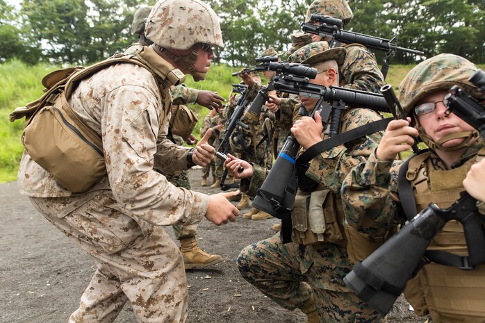 Lance Cpl. Bryant Scott, a Tactical Readiness and Training instructor with Combat Logistics Regiment 37, inspects Marines’ M-16A4 service rifle chambers before they conduct reaction drills during Exercise Dragon Fire 2014 at Combined Arms Training Center Camp Fuji, Japan, July 13. Dragon Fire is CLC-36’s annual Battle Skills Training exercise that focuses on improving the individual and collective combat skills of CLC-36 service members with an emphasis on weapons familiarization training.
