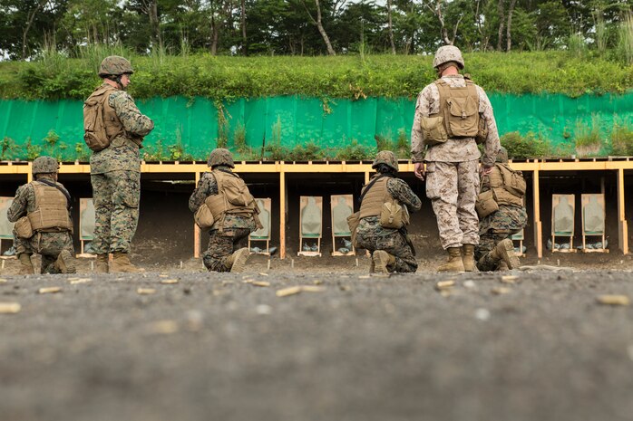 Combat Logistics Company 36 Marines and augments await instructions to fire their M-16A4 service rifles during reaction drills as a part of Exercise Dragon Fire 2014 at Combined Arms Training Center Camp Fuji, Japan, July 13. Dragon Fire is CLC-36’s annual Battle Skills Training exercise that focuses on improving the individual and collective combat skills of CLC-36 service members with an emphasis on weapons familiarization training.
