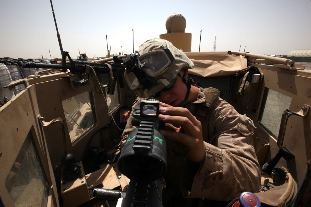 Cpl. Alex Roberts, a turret gunner and weapons noncommissioned officer with Combat Logistics Battalion 7, makes final adjustments to his M240B machine gun in the turret of his Mine-Resistant Ambush Protected vehicle aboard Camp Leatherneck, Afghanistan, July 14, 2014. Roberts, a native of Dunnellon, Fla., and his fellow turret gunners with CLB-7 act as the eyes and ears while being the guardian angels of each combat logistics patrol conducted during their deployment.