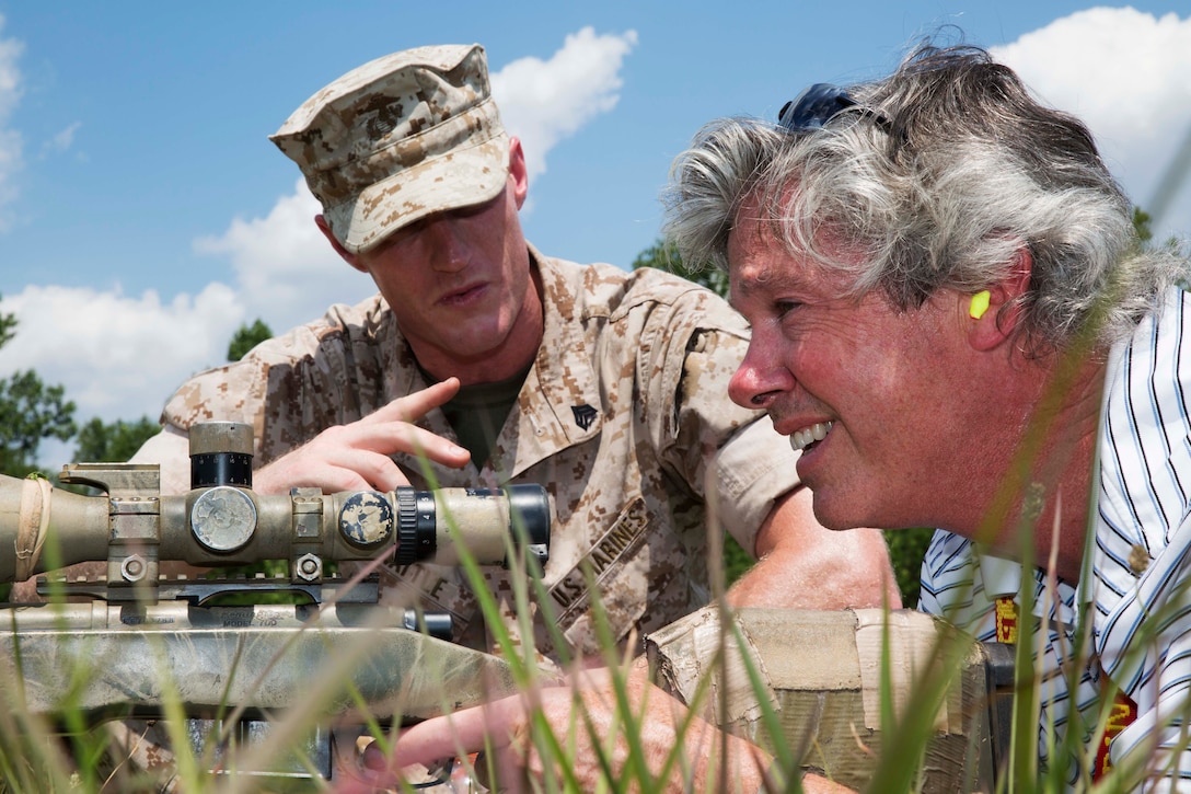 Christopher Hayes, chairman of the board and Revere Bank chair for Vistage International, Inc. in Laurel, Maryland, receives instruction from Sgt. Jason Wattle, a rifleman, about firing an M-40 sniper rifle aboard Marine Corps Base Quantico, Virginia on July 18, 2014. Hayes fired the weapon during a portion of the Marine Corps Executive Forum, an event held several times a year to introduce the Marine Corps to civilians in leadership roles. 