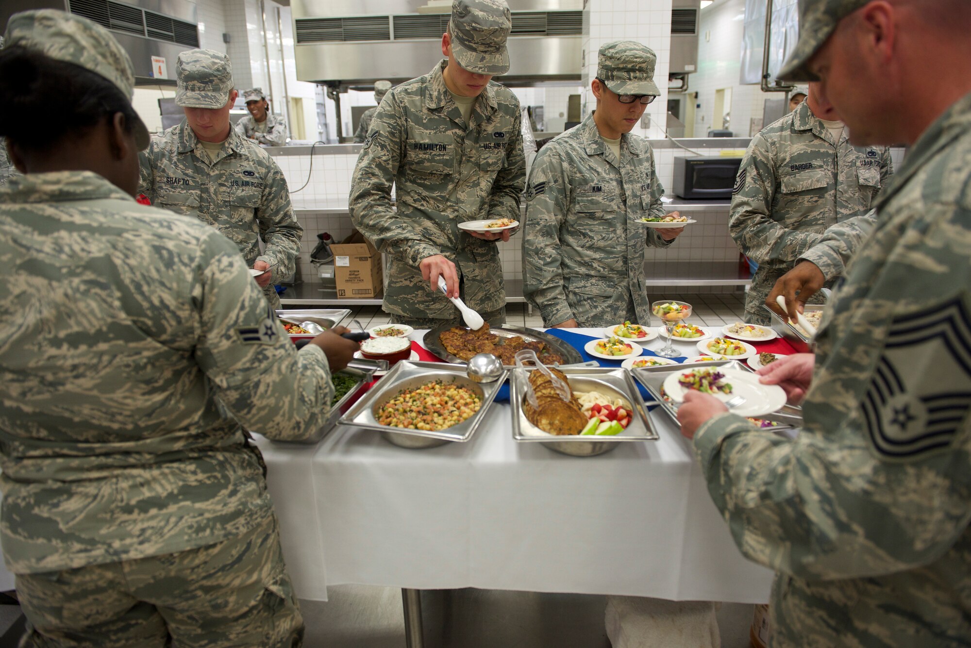 Airmen from the 374th Airlift Wing select healthy breakfast dishes prepared by members of the 374th Force Support Squadron at Yokota Air Base, Japan, July 15, 2014. Services Airmen received hands-on training from Certified Master Chef Hanyzeski to prepare the meals as part of the healthy base initiative. (U.S. Air Force photo by Airman 1st Class David Danford/Released)