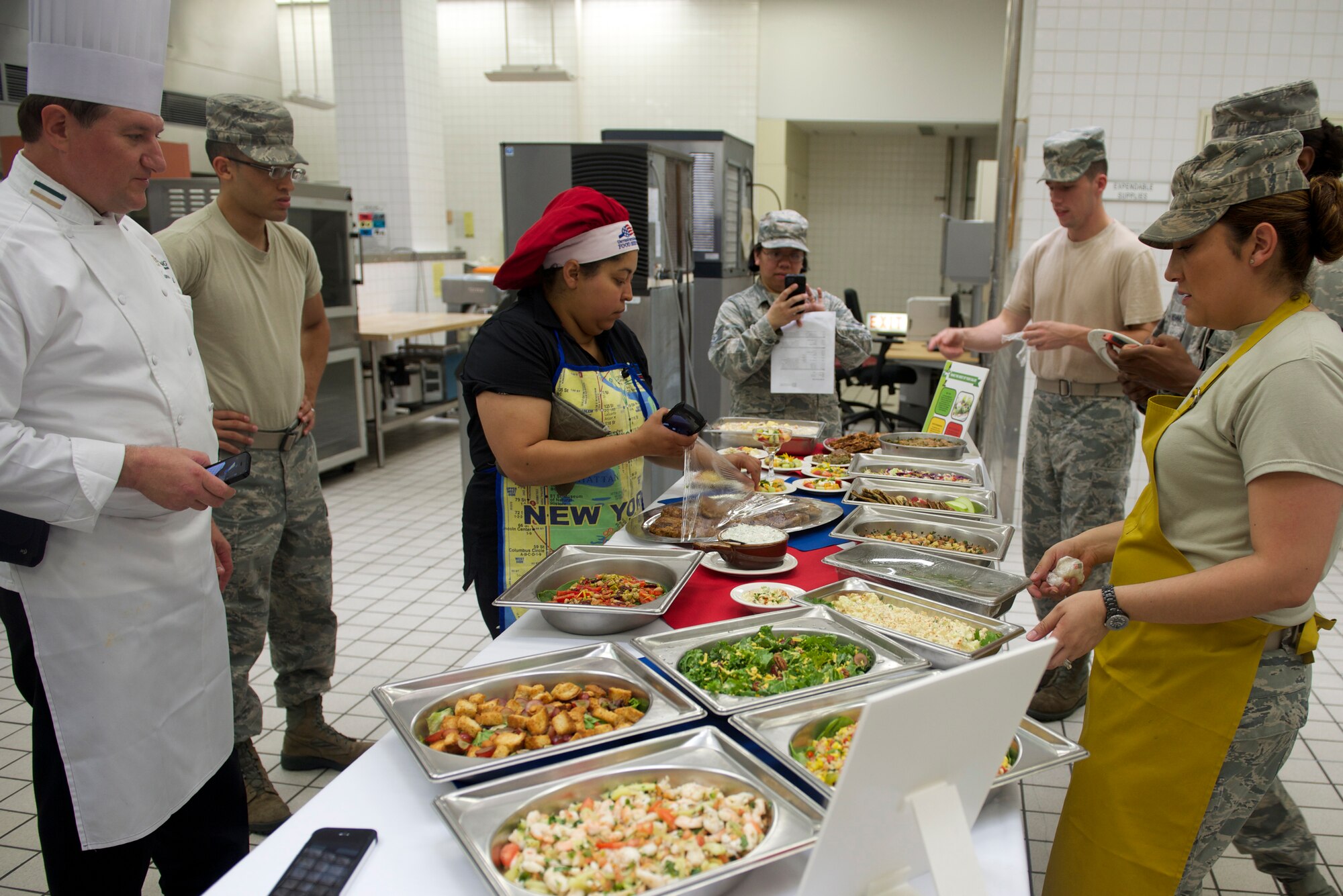 Certified Master Chef James Hanyzeski and Airmen of the 374th Force Support Squadron take photos of the healthy breakfast alternatives they made at Yokota Air Base, Japan, July 15, 2014. Hanyzeski's visit provided hands-on training to services Airmen as part of the Healthy Base Initiative. (U.S. Air Force photo by Airman 1st Class David Danford/Released)