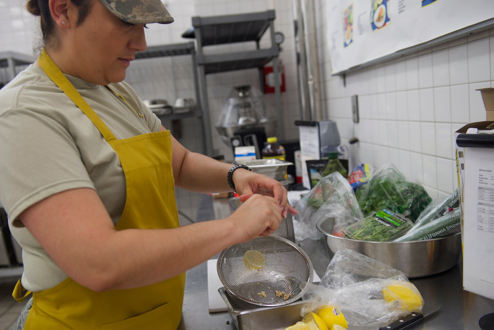 Tech. Sgt. Janet Evans, 374th Force Support Squadron NCO in charge of operations, juices lemons at Yokota Air Base, Japan, July 15, 2014. As part of HBI, services Airmen experiment with alternative garnishes to improve the nutritional value of meals offered at the dining facility. (U.S. Air Force photo by Airman 1st Class David Danford/Released)