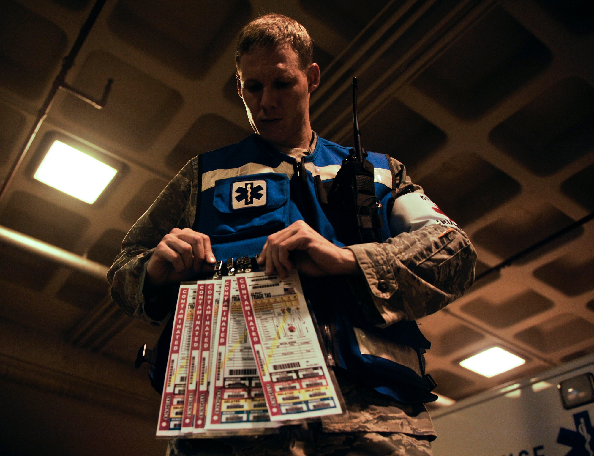 Capt. Ryan Gustafson, 51st Dental Squadron triage doctor, puts triage tags on his vest prior to responding to the simulated aircraft mishap on Osan Air Base, July 23, 2014. The tags provide doctors with information of the patient’s vital signs. (U.S. Air Force photo by Senior Airman David Owsianka)
