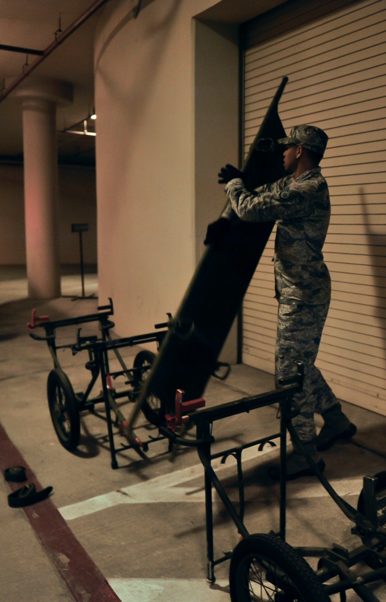 Staff Sgt. Marcos Davis, 51st Medical Operations Squadron physical therapy technician, sets up a litter carry for the simulated aircraft mishap on Osan Air Base, July 23, 2014. The simulated aircraft mishap was designed to test contingency emergency operations, one of five priorities identified by the 51st FW Inspector General Inspections team. (U.S. Air Force photo by Senior Airman David Owsianka)