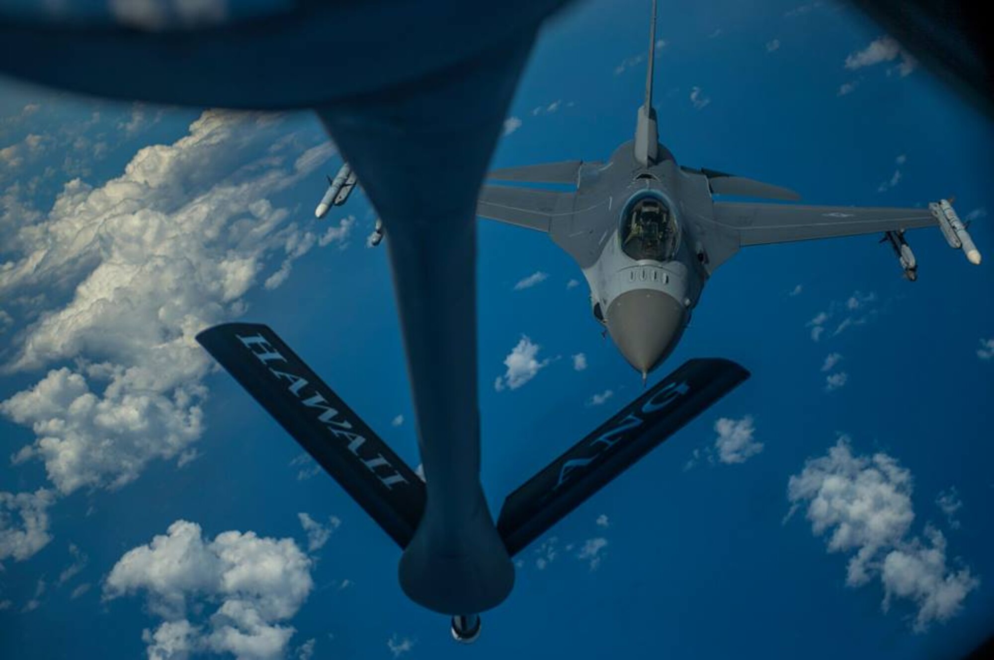 A U.S. Air Force KC-135 Stratotanker from the 96th Air Refueling Wing, refuels a F-16 Fighting Falcon from the 301st Fighter Wing, Naval Air Station Joint Base Fort Worth, during the Rim of the Pacific exercise July 18, 2014, over Hawaii. Twenty-two nations, more than 40 ships, six submarines, and more than 200 aircraft and 25,000 personnel will participate in the biennial Rim of the Pacific (RIMPAC) exercise 2014 scheduled June 26 to Aug. 1, in and around the Hawaiian Islands and Southern California. The world's largest international maritime exercise, RIMPAC provides a unique training opportunity that helps participants foster and sustain cooperative relationships that are critical to ensuring the safety of sea lanes and security on the world's oceans. RIMPAC 2014 is the 24th exercise in the series that began in 1971. (U.S. Air Force photo by Senior Airman James Richardson)
