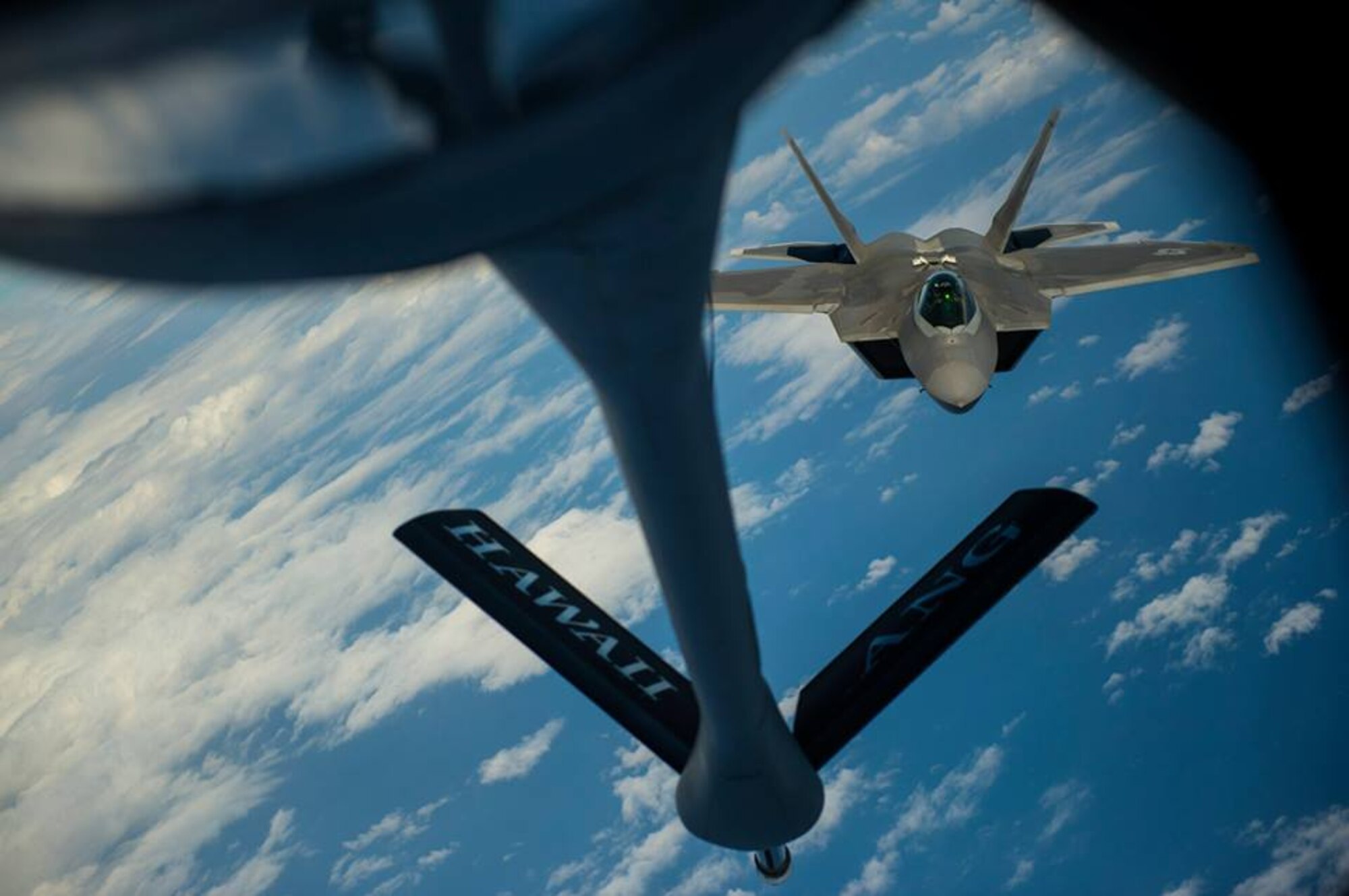 A U.S. Air Force KC-135 Stratotanker from the 96th Air Refueling Wing, refuels a F-22A Raptor from the 199th Fighter Wing during the Rim of the Pacific exercise July 18, 2014, over Hawaii. Twenty-two nations, more than 40 ships, six submarines, and more than 200 aircraft and 25,000 personnel will participate in the biennial Rim of the Pacific (RIMPAC) exercise 2014 scheduled June 26 to Aug. 1, in and around the Hawaiian Islands and Southern California. The world's largest international maritime exercise, RIMPAC provides a unique training opportunity that helps participants foster and sustain cooperative relationships that are critical to ensuring the safety of sea lanes and security on the world's oceans. (U.S. Air Force photo by Senior Airman James Richardson) 