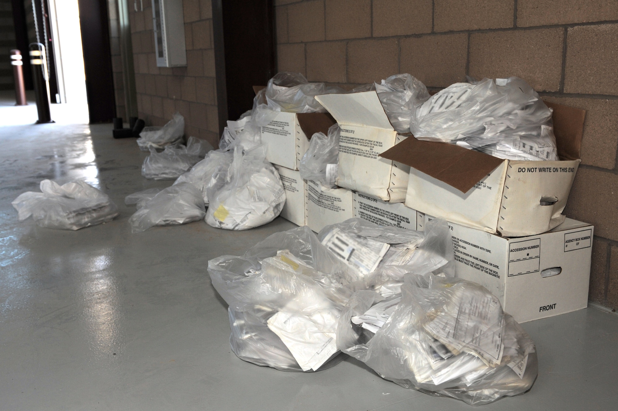 Bags full of wet documents are placed to dry in a warehouse at Davis-Monthan Air Force Base, Ariz., July 21, 2014. The documents were salvaged from the 355th Logistics Readiness Squadron’s customer service building after sustaining water damage attributed to the monsoon storm that hit D-M July 13. (U.S. Air Force photo by Airman 1st Class Chris Drzazgowski /Released)