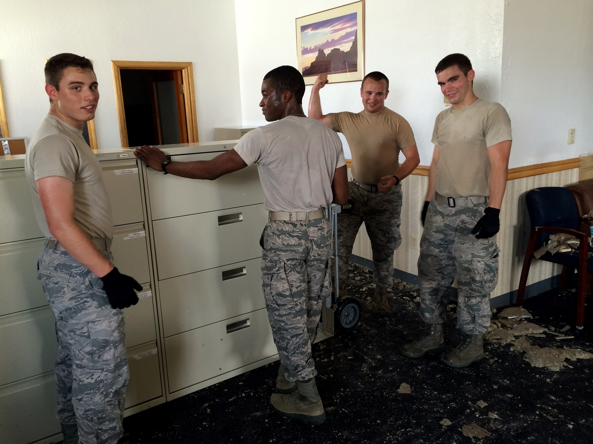 U.S. Air Force Airmen from the 355th Logistics Readiness Squadron prepare to move cabinets out of the squadron’s customer service building at Davis-Monthan Air Force Base, Ariz., July 14, 2014. The move was in order to resume mission support operations which were halted by a monsoon storm July 13. (Courtesy photo)