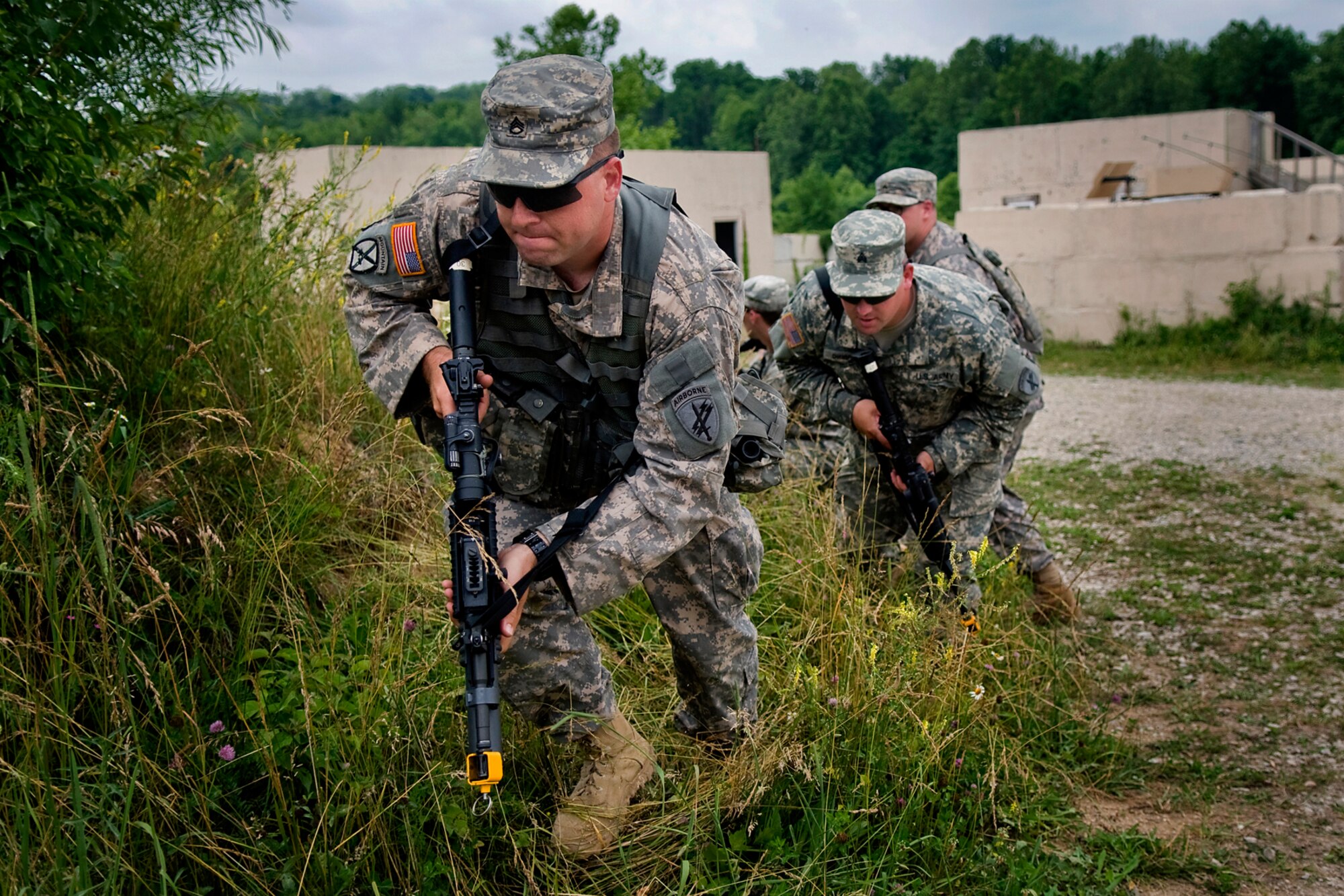 U.S. Army Staff Sgt. Cameron Miller, Sgt. Sean Chamberlain and their fellow 316th Psychological Operations Company PSYOP specialists run to safety as they react to small arms fire during a training scenario at Camp Atterbury Joint Maneuver Training Center, Ind., June 19, 2014. More than 30 PSYOP Soldiers from Grissom Air Reserve Base, Ind., took part in an intensive military support operations training at Camp Atterbury. (U.S. Air Force photo/Tech. Sgt. Mark R. W. Orders-Woempner)