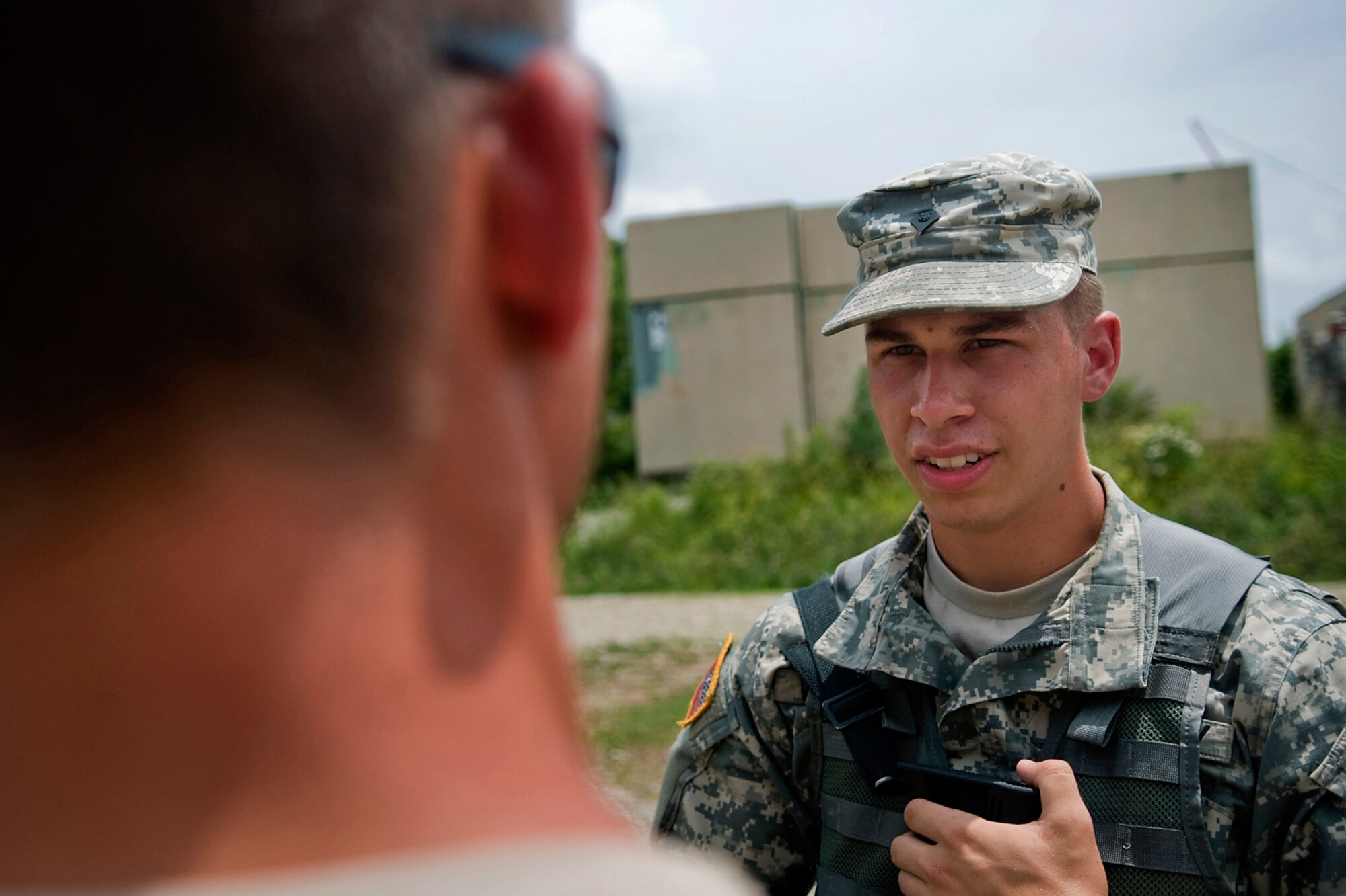 U.S. Army Spc. Alexander Woodall, 316th Psychological Operations Company PSYOP specialist, talks with the mayor of a simulated overseas village during a training scenario at Camp Atterbury Joint Maneuver Training Center, Ind., June 19, 2014. More than 30 PSYOP Soldiers from Grissom Air Reserve Base, Ind., took part in an intensive military support operations training at Camp Atterbury. (U.S. Air Force photo/Tech. Sgt. Mark R. W. Orders-Woempner)