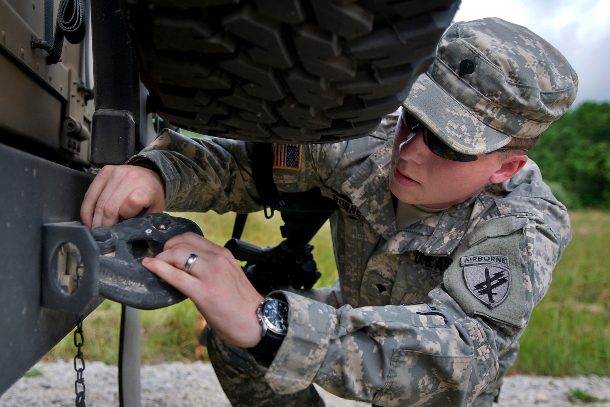 U.S. Army Spc. Jonathan McElheny-Burnett, 316th Psychological Operations Company PSYOP specialist, quickly hooks two Humvees together for towing during a training scenario at Camp Atterbury Joint Maneuver Training Center, Ind., June 19, 2014. More than 30 PSYOP Soldiers from Grissom Air Reserve Base, Ind., took part in an intensive military support operations training at Camp Atterbury. (U.S. Air Force photo/Tech. Sgt. Mark R. W. Orders-Woempner)
