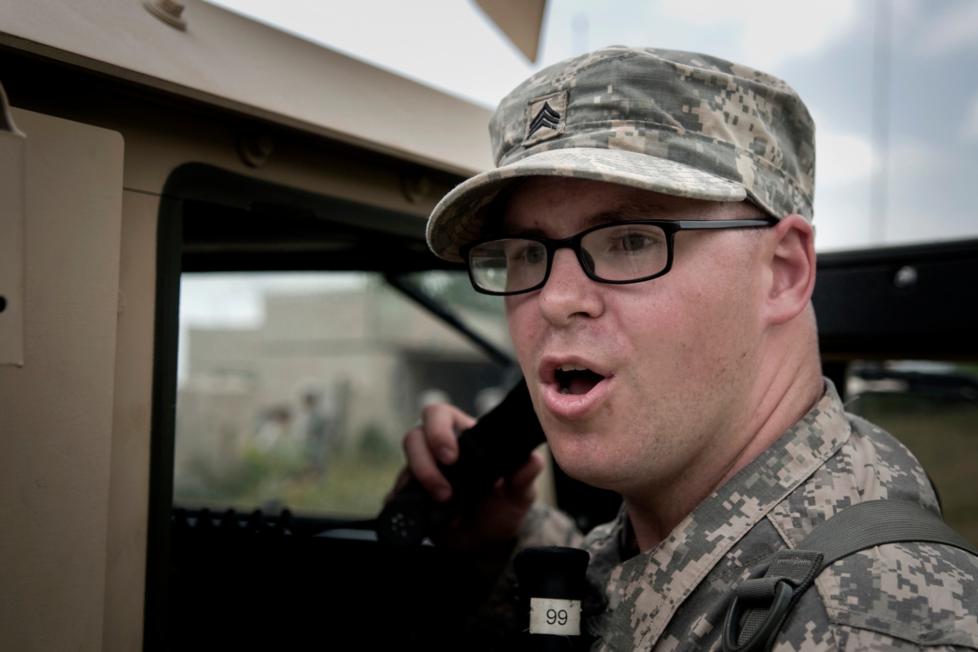 U.S. Army Sgt. John Kitchell, 316th Psychological Operations Company PSYOP sergeant, commands his fellow Soldiers during a training scenario at Camp Atterbury Joint Maneuver Training Center, Ind., June 19, 2014. More than 30 PSYOP Soldiers from Grissom Air Reserve Base, Ind., took part in an intensive military support operations training at Camp Atterbury. (U.S. Air Force photo/Tech. Sgt. Mark R. W. Orders-Woempner)
