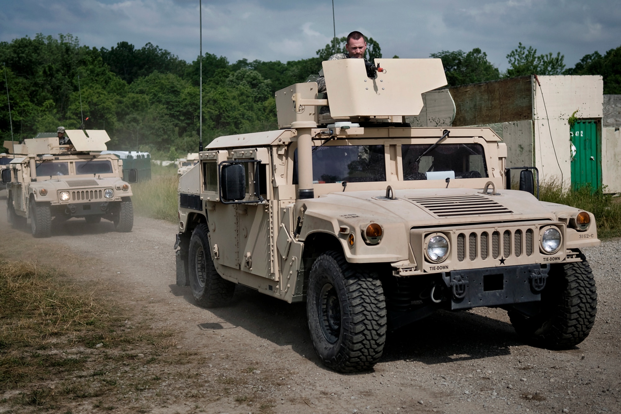 U.S. Army Soldiers from the 316th Psychological Operations Company drive into a simulated village during a training scenario at Camp Atterbury Joint Maneuver Training Center, Ind., June 19, 2014. More than 30 PSYOP Soldiers from Grissom Air Reserve Base, Ind., took part in an intensive military support operations training at Camp Atterbury. (U.S. Air Force photo/Tech. Sgt. Mark R. W. Orders-Woempner)
