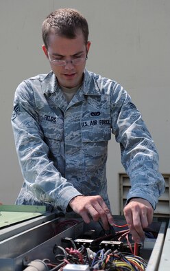 Senior Airman William Fields checks the continuity on fuses to determine if the load safeties are deficient from the main power line to the condensing air conditioning units at Fairchild Air Force Base, Washington on July 21, 2014. As a heating, ventilation and air conditioning journeymen, Fields daily work is mostly consumed with preventative maintenance on infrastructure equipment throughout the base. The 92nd Civil Engineer Squadron is responsible for keeping all air conditioning systems running, heating, cooling, refrigeration and some domestic water heaters. (U.S. Air Force photo by Staff Sgt. Samantha Krolikowski/Released)