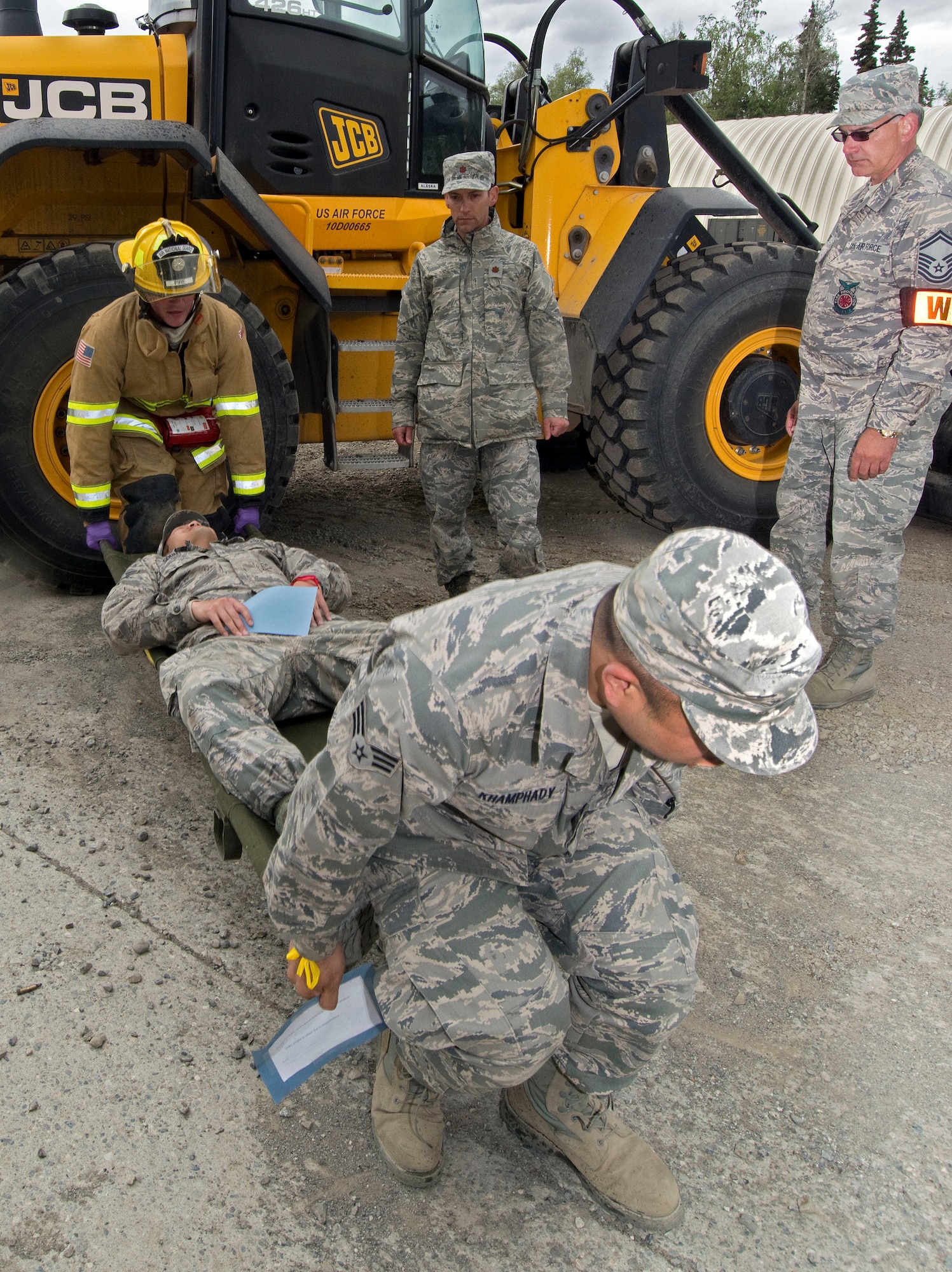 Firefighters and other 176 Civil Engineering Squadron members practice rescue techniques during an exercise at Camp Mad Bull here June 9, 2014. The 176 Mission Support Group and the 176 Medical Group participated as part of Polar Guardian 14-2. (U.S. Air National Guard photo by Capt. John Callahan)