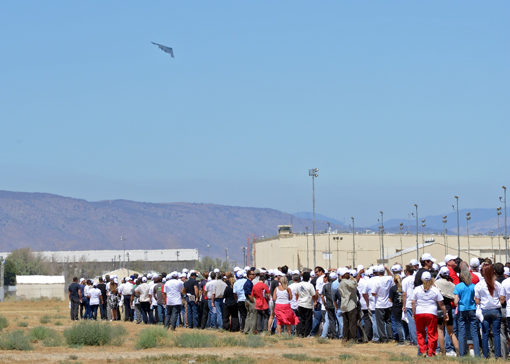 Crowds of Northrop Grumman employees, civic leaders and military personnel watch a B-2 Spirit take to the sky, reenacting the first takeoff of the B-2. (U.S. Air Force photo by Jet Fabara)