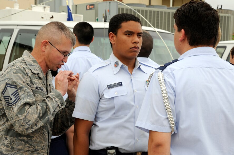 Senior Master Sgt. James McClure, 2nd Force Support Squadron and former Military Training Instructor, corrects a Civil Air Patrol cadet during drill training at Barksdale Air Force Base, La., July 20, 2014. Three former MTI's  instructed the cadets on basic flight formation, movements and commands to give them a small taste of what basic training is like. (U.S. Air Force photo/Tech. Sgt. Marie Brown)