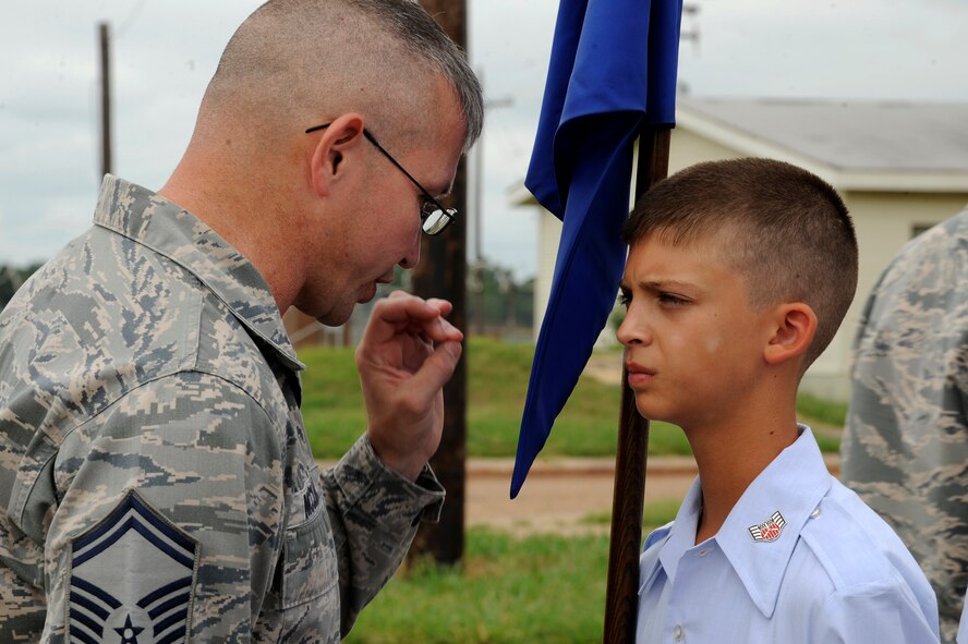 Senior Master Sgt. James McClure, 2nd Force Support Squadron and former Military Training Instructor, corrects a Civil Air Patrol cadet during drill training at Barksdale Air Force Base, La., July 20, 2014. Three former MTI's taught the cadets basic flight movements and commands during drill training. (U.S. Air Force photo/Tech. Sgt. Marie Brown)