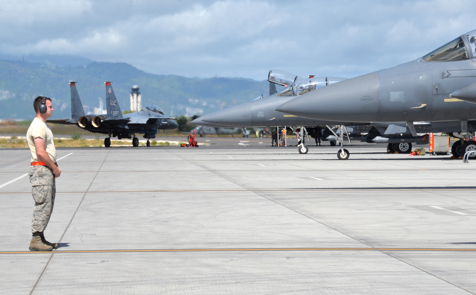 A 391st Fighter Squadron crew chief prepares to guide an F-15E Strike Eagle during a mission July 16, 2014, at Joint Base Pearl Harbor-Hickam, Hawaii. The 391st FS is currently on a two-month deployment here from Mountain Home Air Force Base, Idaho. While here, the squadron’s F-15Es have participated in Rim of the Pacific 2014 exercise missions. RIMPAC is a U.S. Pacific Command-hosted biennial multinational maritime exercise designed to foster and sustain international cooperation on the security of the world’s oceans. (U.S. Air Force photo by Staff Sgt. Alexander Martinez/Released)