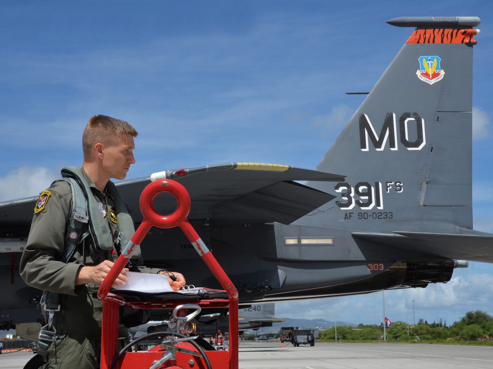 Lt. Col. Gary Marlowe, 391st Fighter Squadron F-15E Strike Eagle pilot and Director of Operations, checks pre-flight paperwork during a mission July 16, 2014, at Joint Base Pearl Harbor-Hickam, Hawaii. The 391st FS is currently on a two-month deployment here from Mountain Home Air Force Base, Idaho. While here, the squadron’s F-15Es have participated in Rim of the Pacific 2014 exercise missions. RIMPAC is a U.S. Pacific Command-hosted biennial multinational maritime exercise designed to foster and sustain international cooperation on the security of the world’s oceans. (U.S. Air Force photo by Staff Sgt. Alexander Martinez/Released)