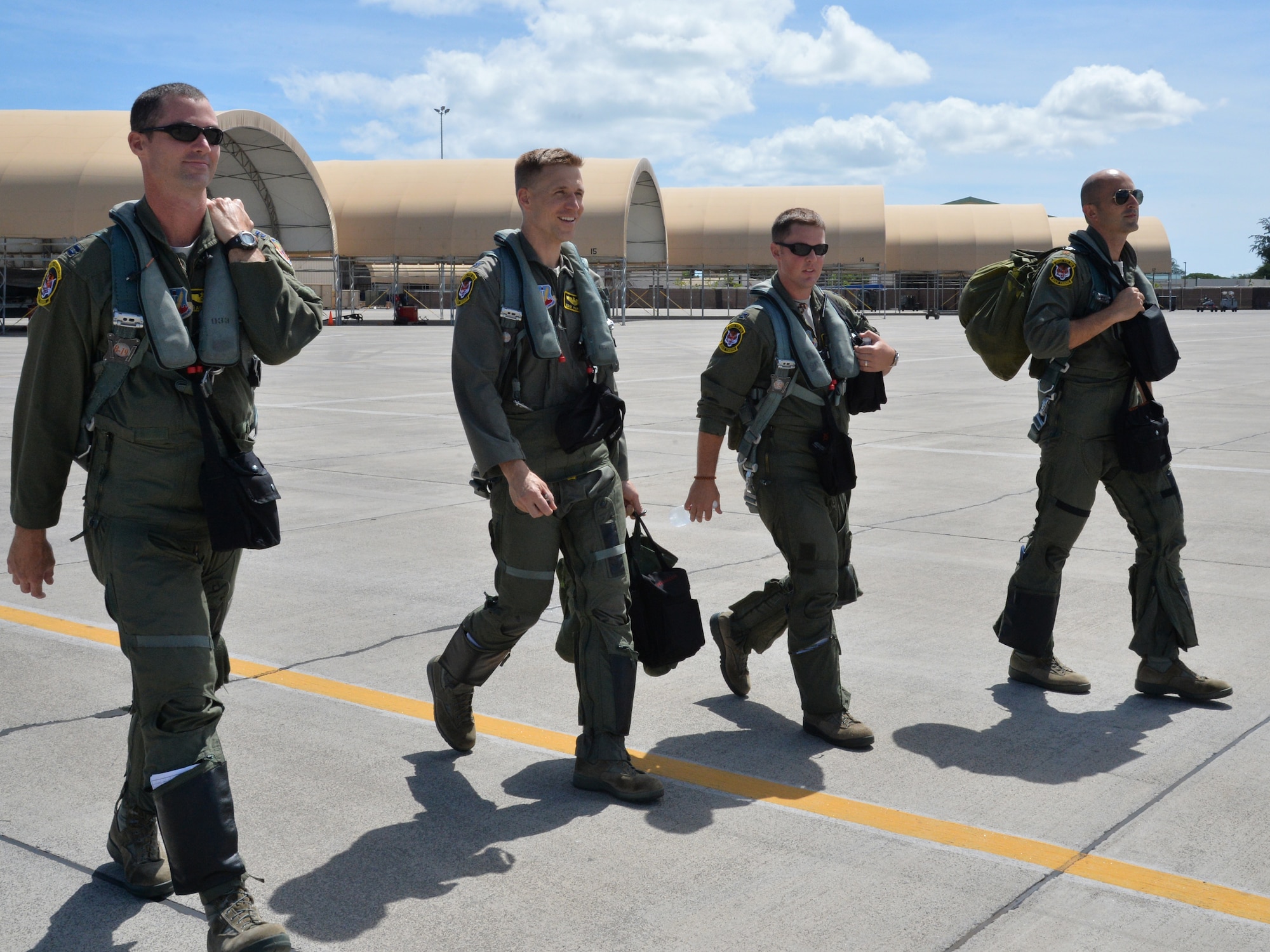 391st Fighter Squadron F-15E Strike Eagle pilots and weapon systems officers step to their aircrafts during a mission July 16, 2014, at Joint Base Pearl Harbor-Hickam, Hawaii. The 391st FS is currently on a two-month deployment here from Mountain Home Air Force Base, Idaho. While here, the squadron’s F-15Es have participated in Rim of the Pacific 2014 exercise missions. RIMPAC is a U.S. Pacific Command-hosted biennial multinational maritime exercise designed to foster and sustain international cooperation on the security of the world’s oceans. (U.S. Air Force photo by Staff Sgt. Alexander Martinez/Released)