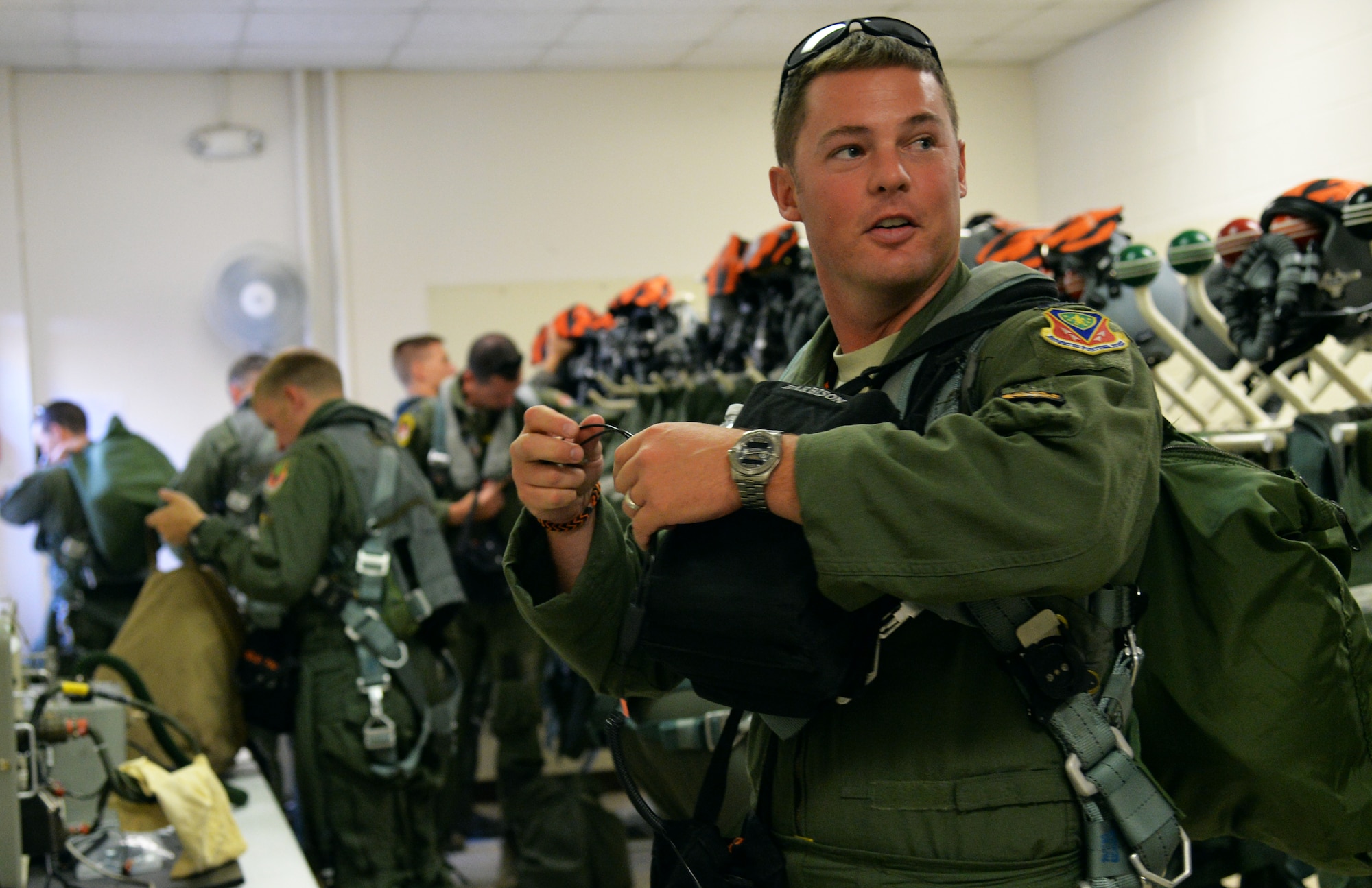 Capt. Scott Harbison, 391st Fighter Squadron F-15E Strike Eagle pilot, gears up for a mission July 16, 2014, at Joint Base Pearl Harbor-Hickam, Hawaii. The 391st FS is currently on a two-month deployment here from Mountain Home Air Force Base, Idaho. While here, the squadron’s F-15Es have participated in Rim of the Pacific 2014 exercise missions. RIMPAC is a U.S. Pacific Command-hosted biennial multinational maritime exercise designed to foster and sustain international cooperation on the security of the world’s oceans. (U.S. Air Force photo by Staff Sgt. Alexander Martinez/Released)