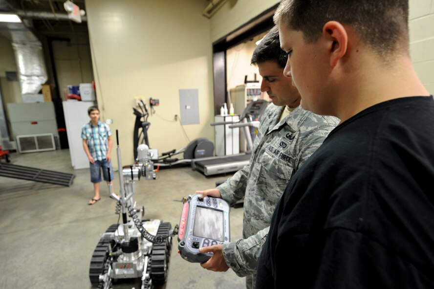 Staff Sgt. Justin Beasley, 4th Civil Engineer Squadron explosive ordnance disposal journeyman, performs an EOD robot demonstration July 21, 2014, at Seymour Johnson Air Force Base, North Carolina. Airmen of the 4th CES EOD shop invited students from the local community to learn about practical application of robotics in the military. (U.S. Air Force photo/Airman 1st Class Aaron J. Jenne)