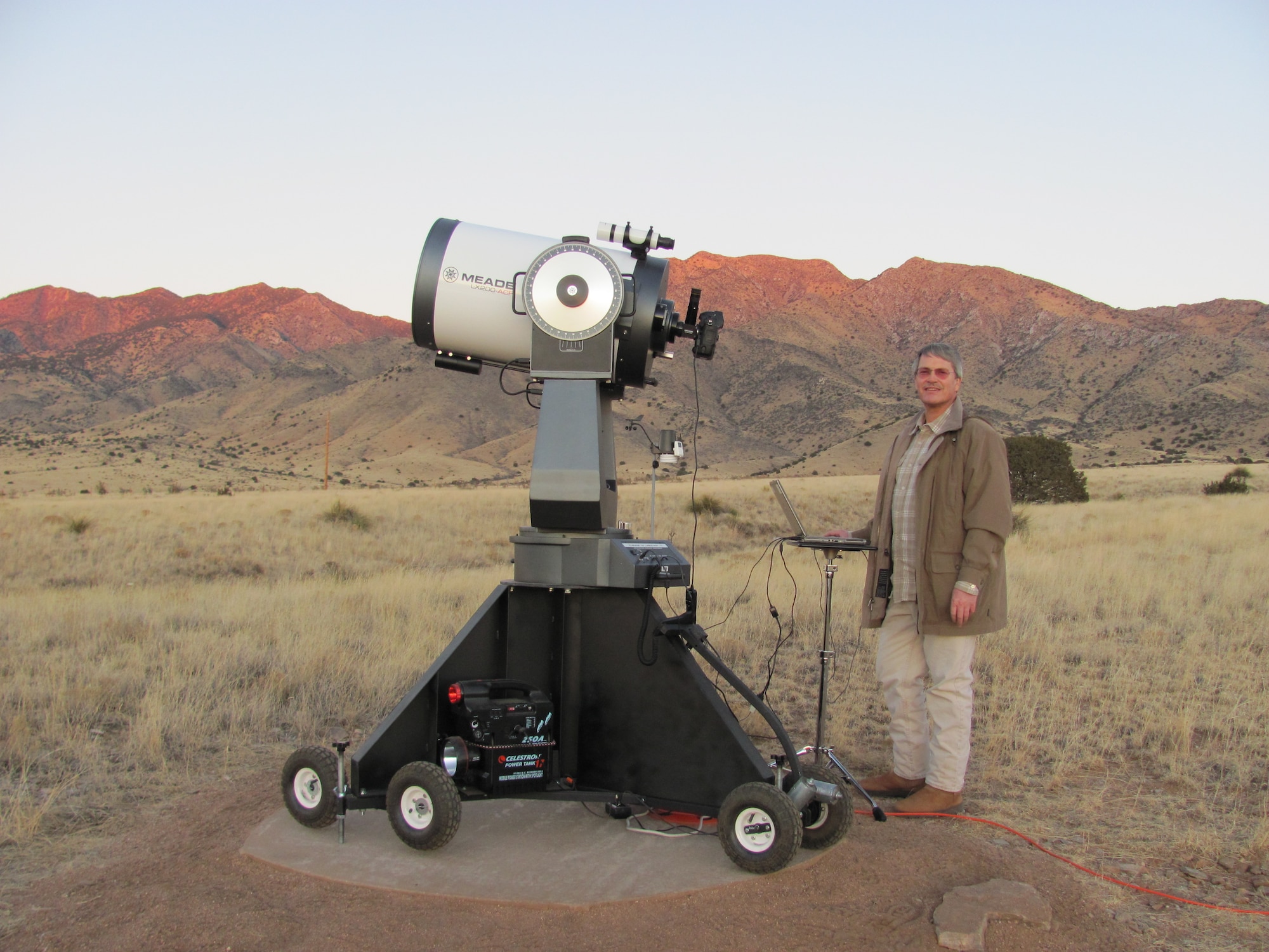 Dr. Richard Rast, senior engineer with the Air Force Research Laboratory's Satellite Assessment Center, stands by a 16-inch diameter telescope.  Small telescopes are less expensive and more portable than large telescopes. (Photo courtesy of Dr. Richard Rast, AFRL/Directed Energy Directorate)