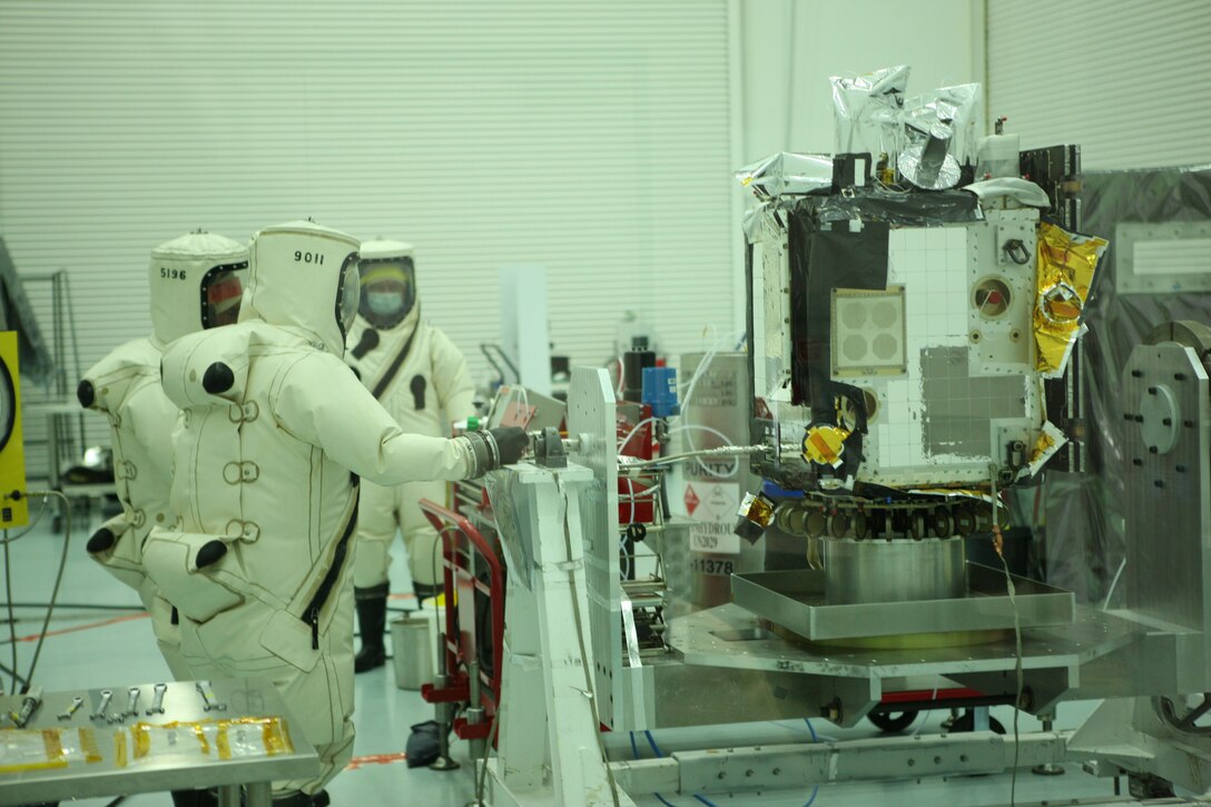 ATA Aerospace and Air Force Research Laboratory Space Vehicles personnel conduct fueling activities prior to a satellite launch near Cape Canaveral, Fla. The AFRL's Automated Navigation and Guidance Experiment for Local Space satellite is scheduled for launch July 23. (Courtesy photo)