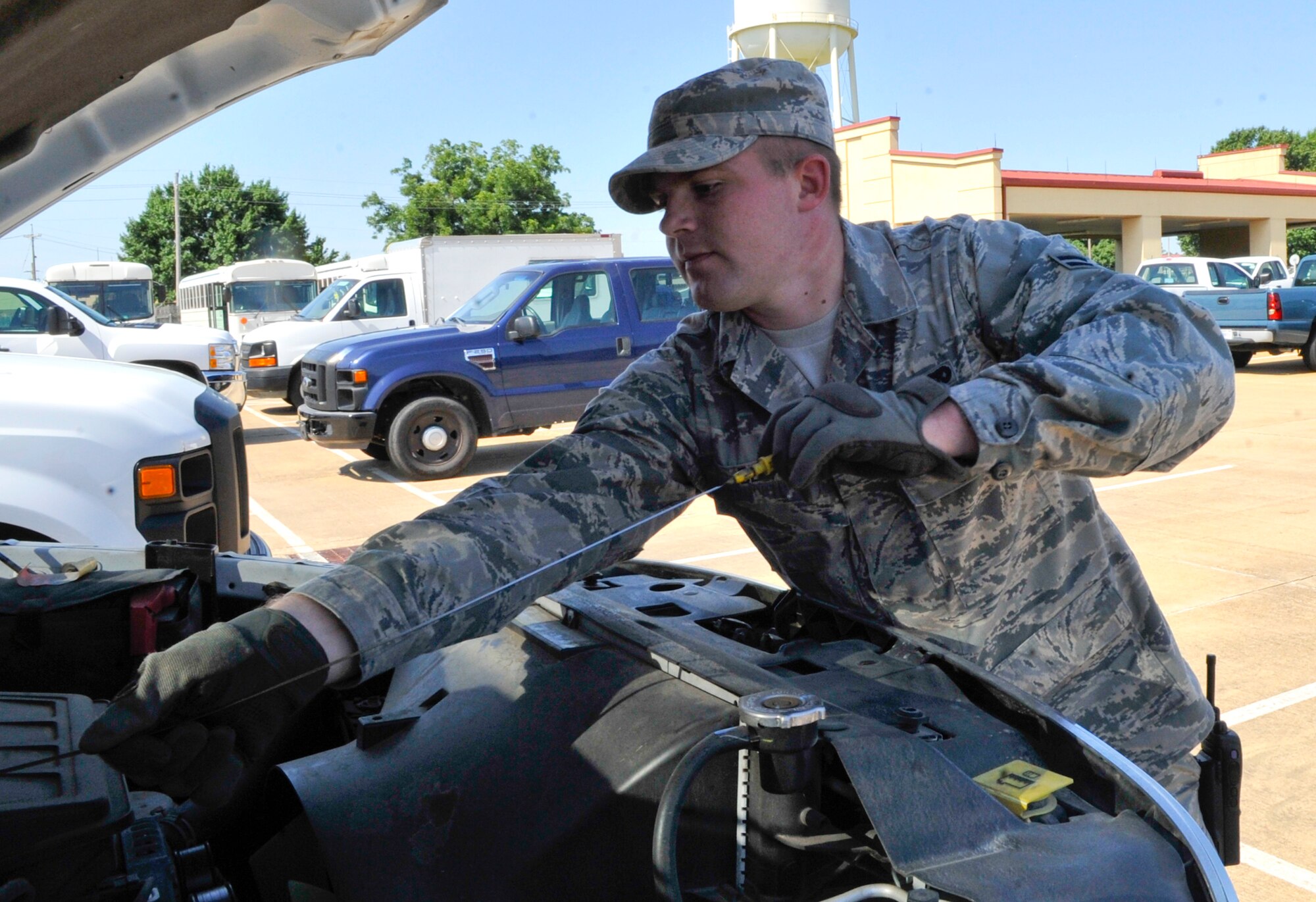 Airman 1st Class Oliver Delfs, 2nd Logistics Readiness Squadron vehicle operator, checks the engine oil in a government-owned vehicle on Barksdale Air Force Base, La., July 16, 2014. The 2nd LRS Vehicle Operations flight maintains Team Barksdale's logistical order by delivering parts to maintainers, aircrew to the B-52H Stratofortress, government-owned vehicles, or GOV's to customers and more. (U.S. Air Force photo/Airman 1st Class Benjamin Raughton)