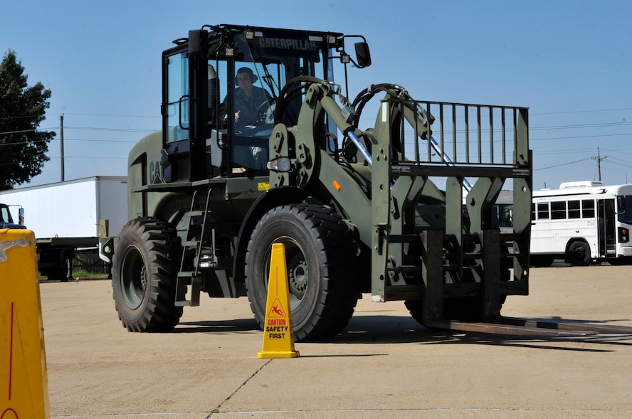 Airman 1st Class Oliver Delfs, 2nd Logistics Readiness Squadron vehicle operator, maneuvers a forklift between cones during a training exercise on Barksdale Air Force Base, La., July 16, 2014. Vehicle Ops Airmen train on multiple kinds of vehicles, such as forklifts and tractor trailers, to provide quick, reliable logistical support to meet Team Barksdale's mission requirements. (U.S. Air Force photo/Airman 1st Class Benjamin Raughton)