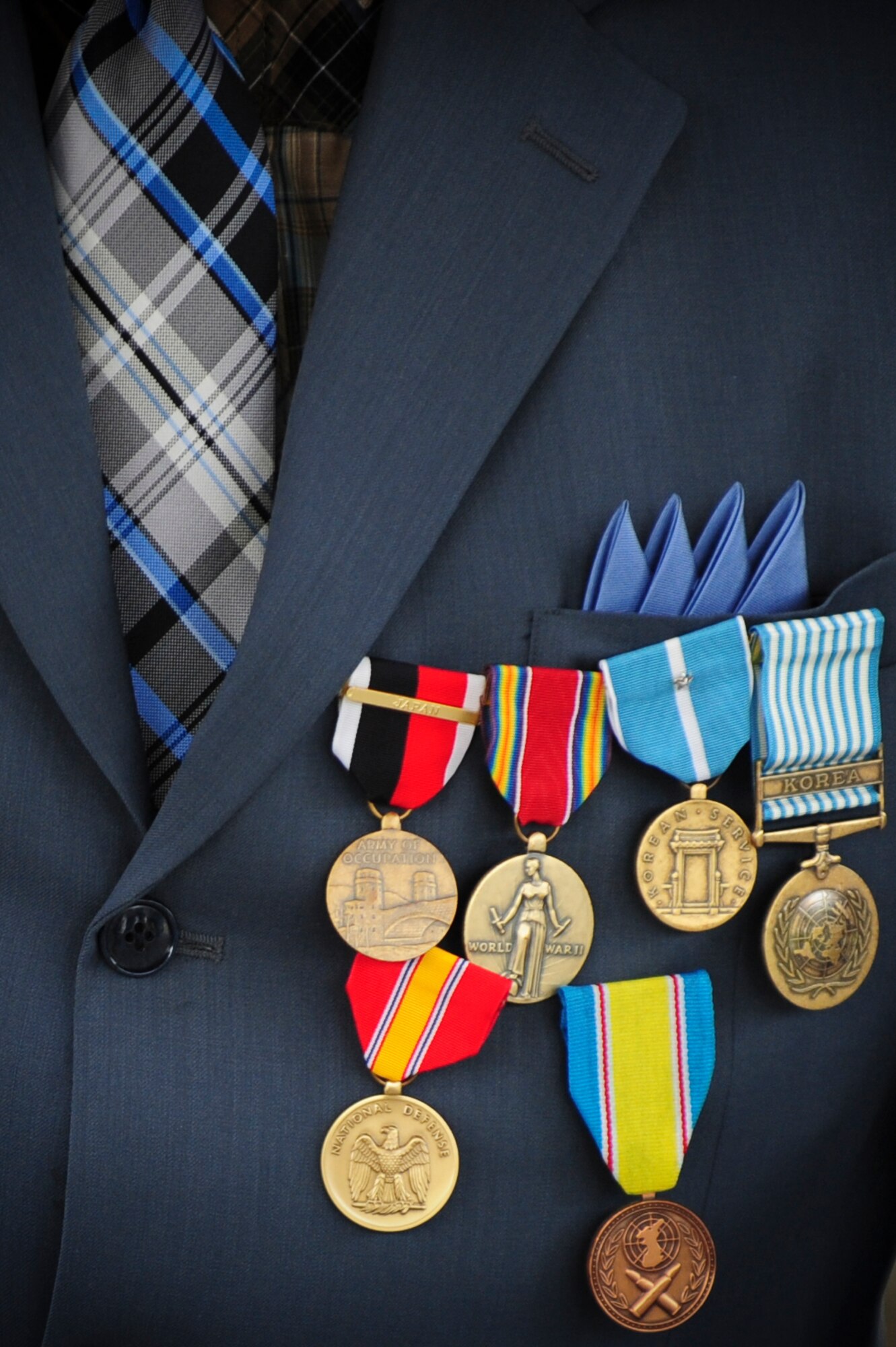 Retired Staff Sgt. Elbert Scott wears his six service medals he received during a medal presentation ceremony in his honor, July 21, 2014, in downtown Goldsboro, North Carolina. Scott was presented with the Occupation of Japan Award, the WWII Victory Medal, the Korean Service Medal with one Silver Star, the United Nations Service Medal, the National Defense Service Medal and the 50th Anniversary of the Korean War Medal. (U.S. Air Force photo/Airman 1st Class Brittain Crolley)