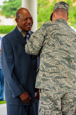 Col. Andrew Bernard, 4th Fighter Wing vice commander, pins a medal on retired Staff. Sgt. Elbert Scott during a medal presentation ceremony, July 21, 2014, in downtown Goldsboro, North Carolina. Scott served in both the U.S. Army and U.S. Air Force from 1945-1966. (U.S. Air Force photo/Airman 1st Class Brittain Crolley)