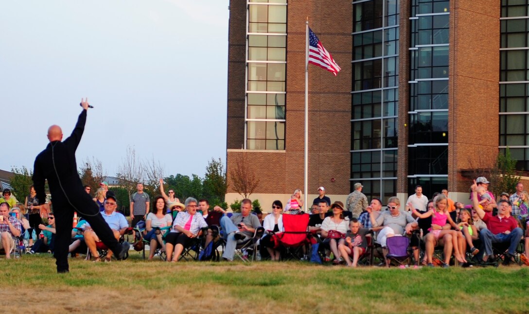 Senior Master Sgt. Ryan Carson, a vocalist for "Max Impact," interacts with audience members at the Joint Base Andrews Heritage Park Concert, July 12, 2014. The concert series was designed to show appreciation to the local community for their support and showcase JBA's dedicated Airmen. This was the second of three concerts scheduled for this summer. (US Air Force photo by Staff Sgt. Torey Griffith/released)