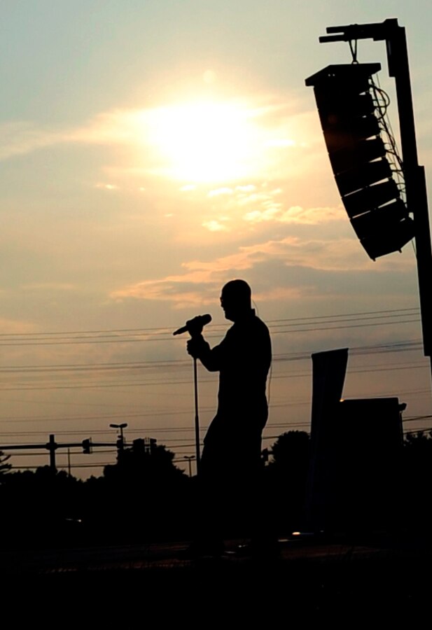 Senior Master Sgt. Ryan Carson, vocalist for "Max Impact," performs at the Joint Base Andrews Heritage Park Concert, July 12, 2014. The concert series was designed to show appreciation to the local community for their support and showcase JBA's dedicated Airmen. This was the second of three concerts scheduled for this summer. (US Air Force photo by Staff Sgt. Torey Griffith/released)