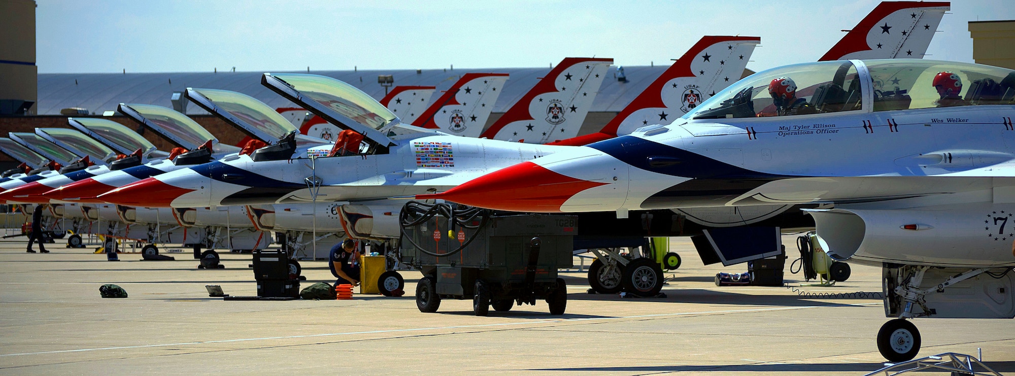 Maj. Tyler Ellison, U.S. Air Force Thunderbirds #7 pilot, and Wes Welker, Denver Broncos wide receiver, begin their final preparations for take-off July 20 during a media flight out of the Wyoming Air National Guard Base, Cheyenne, Wyo. Crews perform routine maintenance on the rest of the aircrafts, preparing them for an upcoming air show. (U.S. Air Force photo by Airman 1st Class Brandon Valle)