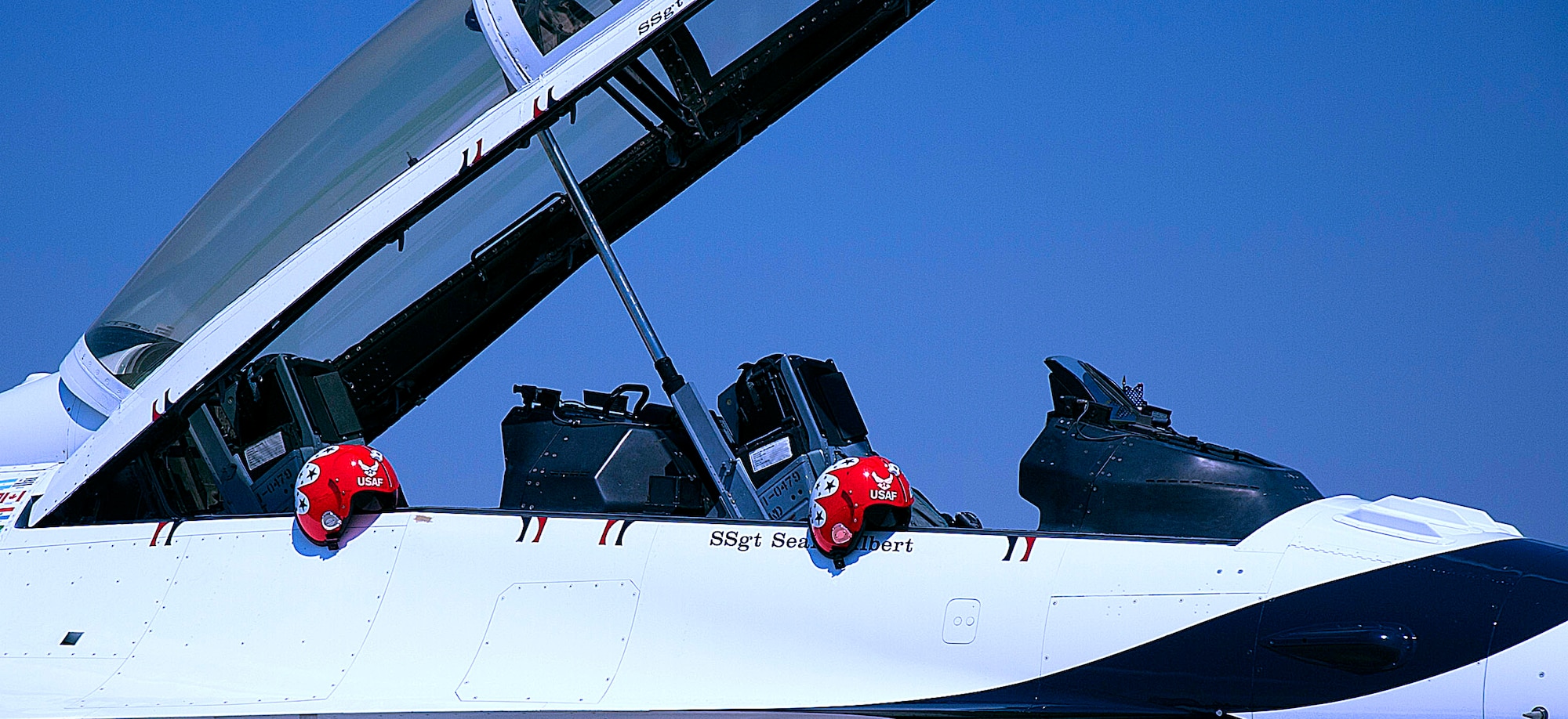 Two helmets sit on the side of a U.S. Air Force Thunderbirds F-16 July 20 as the aircraft is prepared for a media flight. The Thunderbirds provided two media flights to help showcase their skills and bring awareness of the daily activities they perform. (U.S. Air Force photo by Airman 1st Class Brandon Valle) 