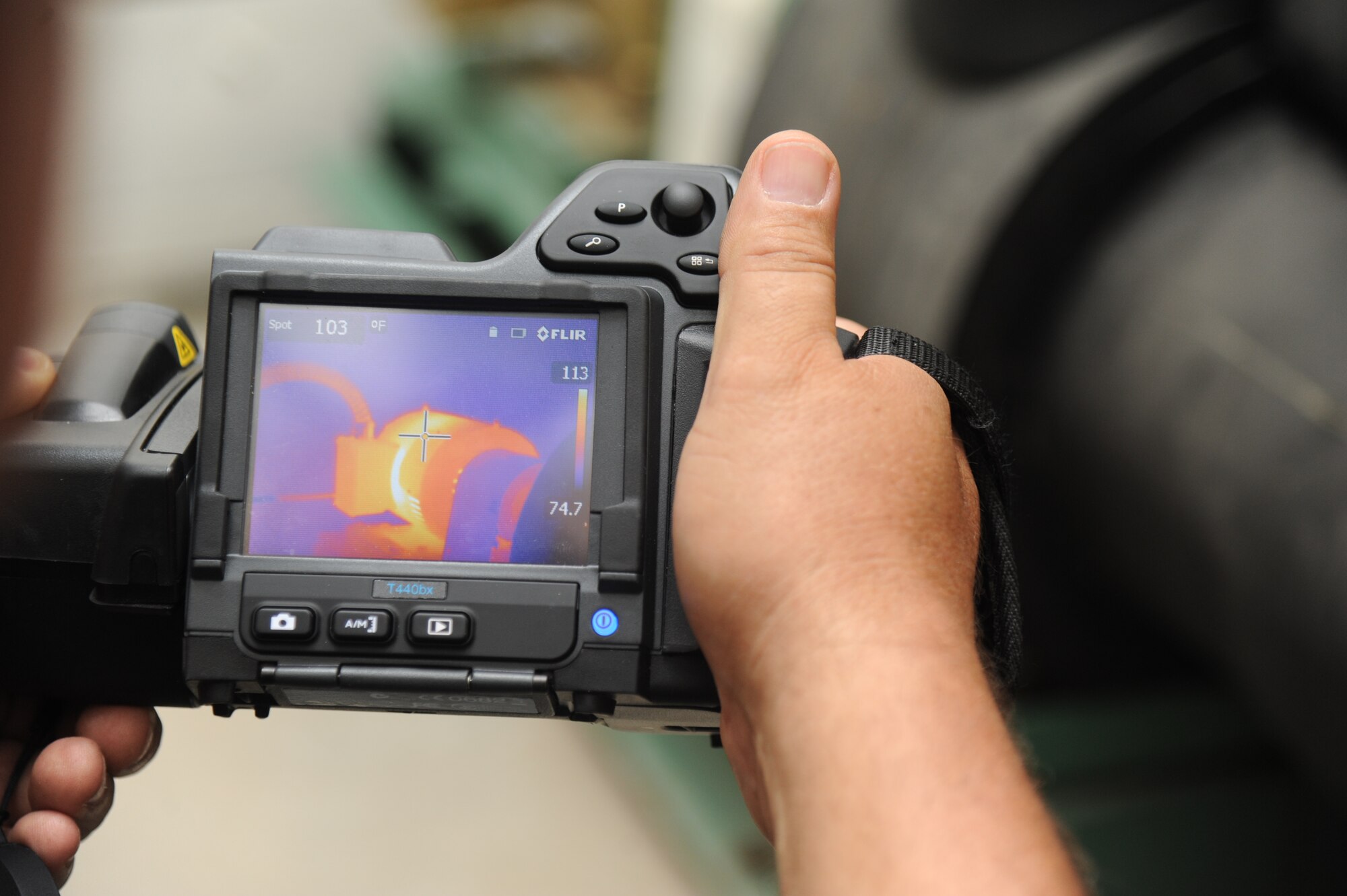 John Grant, Base Operations Support contractor, uses a Thermal Imaging System used for detecting mechanical hot spots inside the 41st Aerial Port building mechanical room July 18, 2014, at Keesler Air Force Base, Miss.  This system is utilized as part of the Reliability Centered Maintenance program which evaluates equipment performance piece by piece to determine wear and lifecycle of each item.  The goal of the program is to institute the most cost effective plan for maintaining complex systems and minimize equipment failure or downtime. (U.S. Air Force photo by Kemberly Groue)